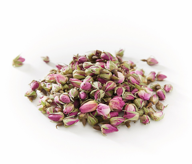 premium persian rose buds white background with a pile of pink persian rose buds