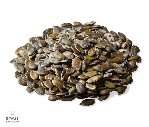 white background with a pile of dark green pumpkin seeds